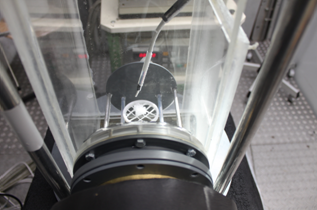 Shown is the insulated box which is fixed at the wall of the experimental section of the wind tunnel. The rime collector is exposed in the center of the section and, thus, in the cloud of supercooled droplets. The temperature is measured downstream of the rime collector.